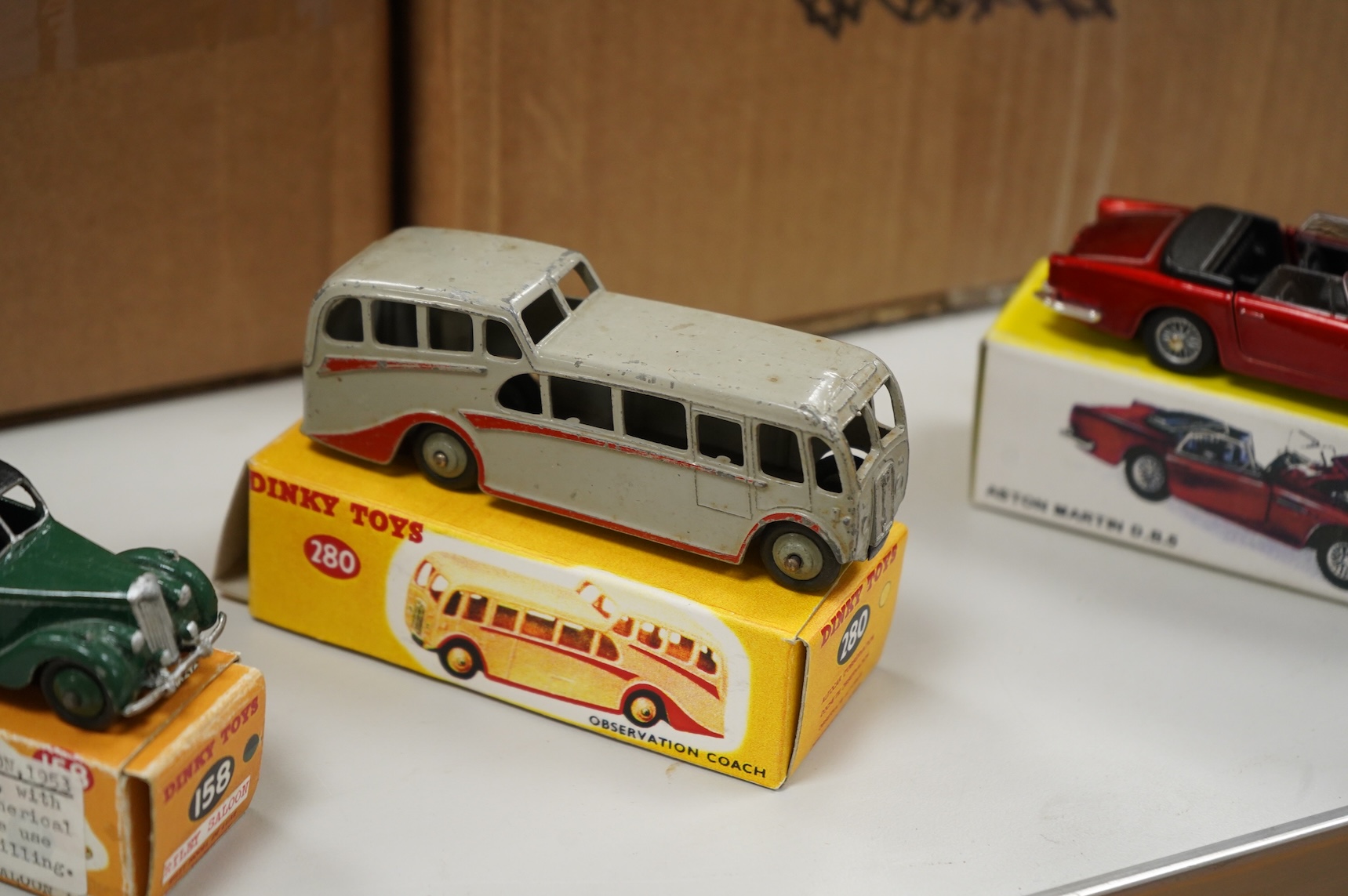 Thirty-two Dinky Toys, all playworn, restored, repainted or overpainted examples in reproduction boxes, including cars and light commercial vehicles
